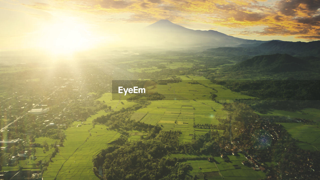 Aerial view of agricultural landscape against bright sun