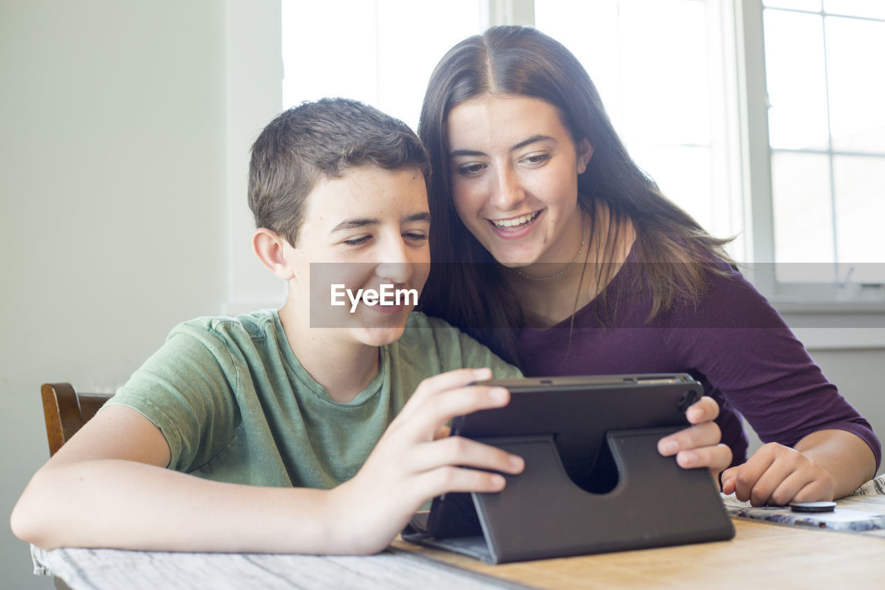 Teenagers looking at digital tablet
