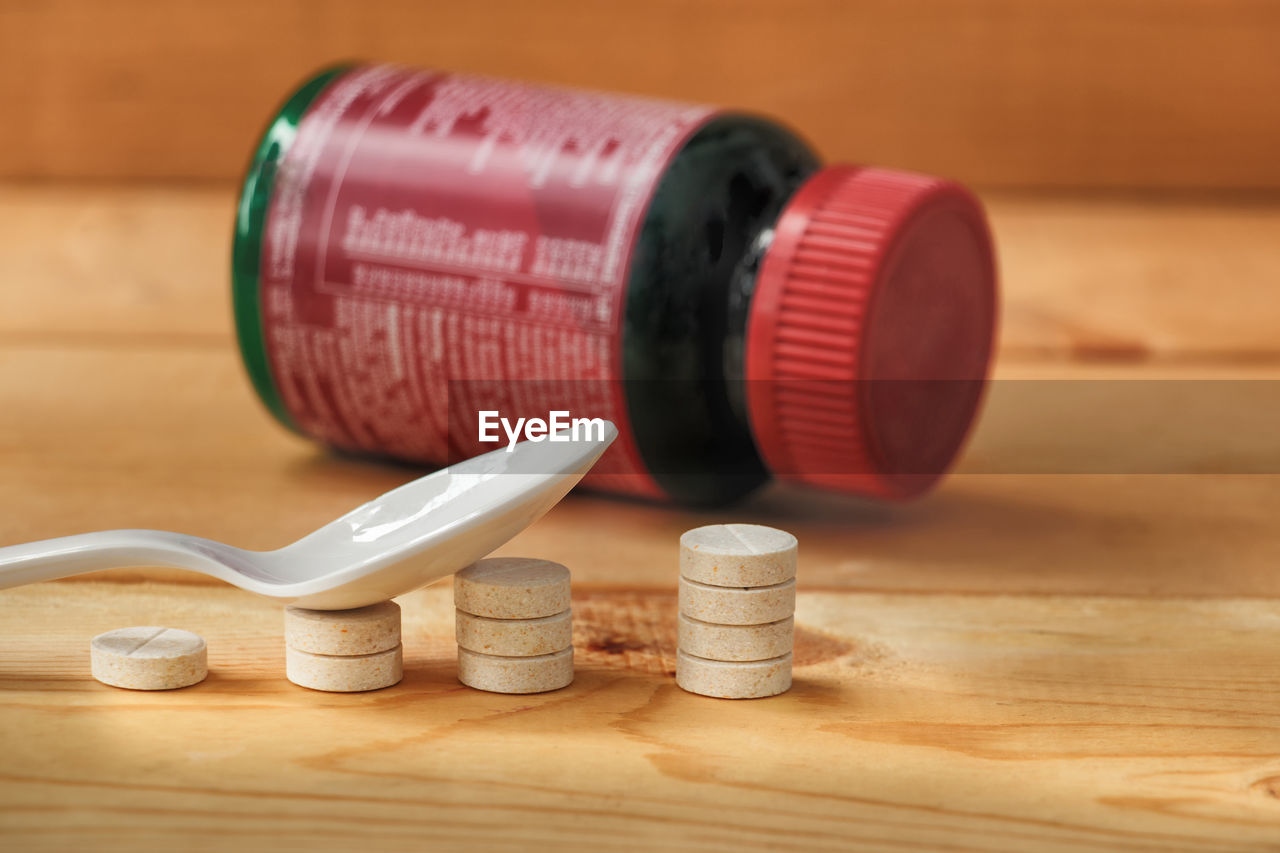 Close-up of medicines on wooden table