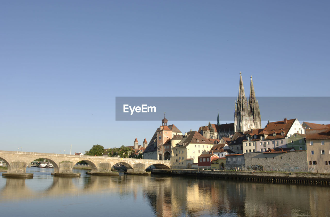 TOWN BY RIVER AGAINST CLEAR SKY