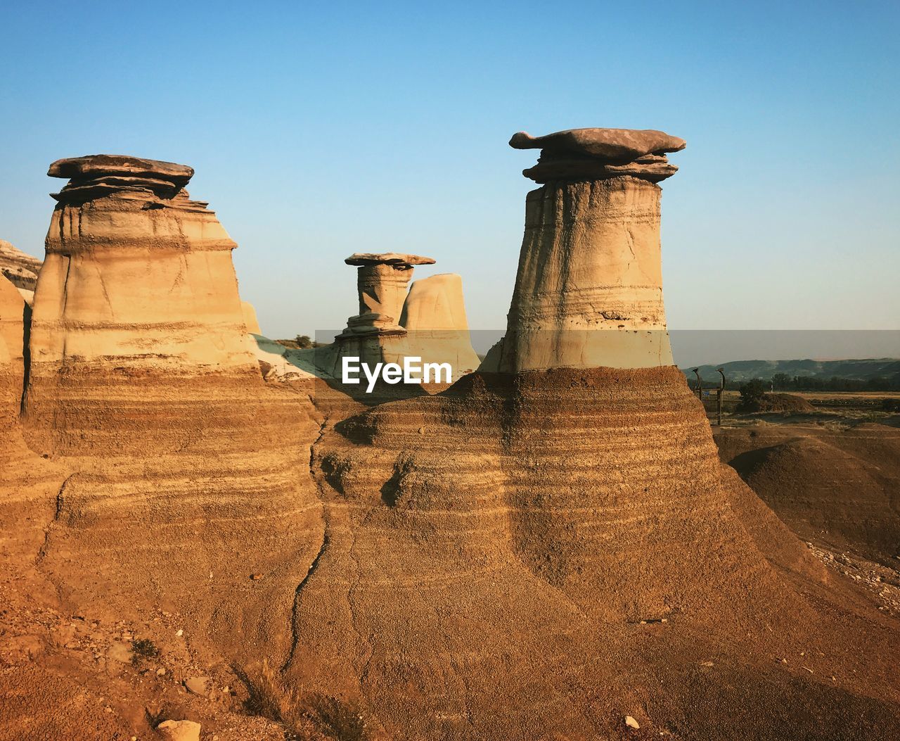 Rock hoodoo at drumheller against clear sky