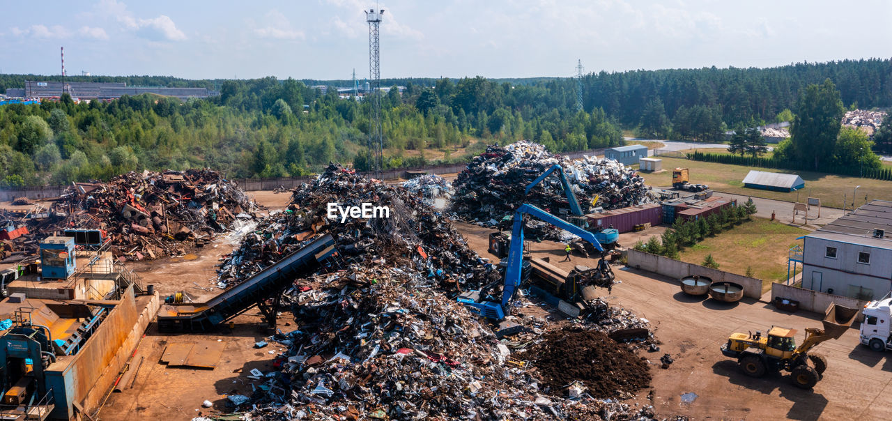 Old damaged cars on the junkyard waiting for recycling