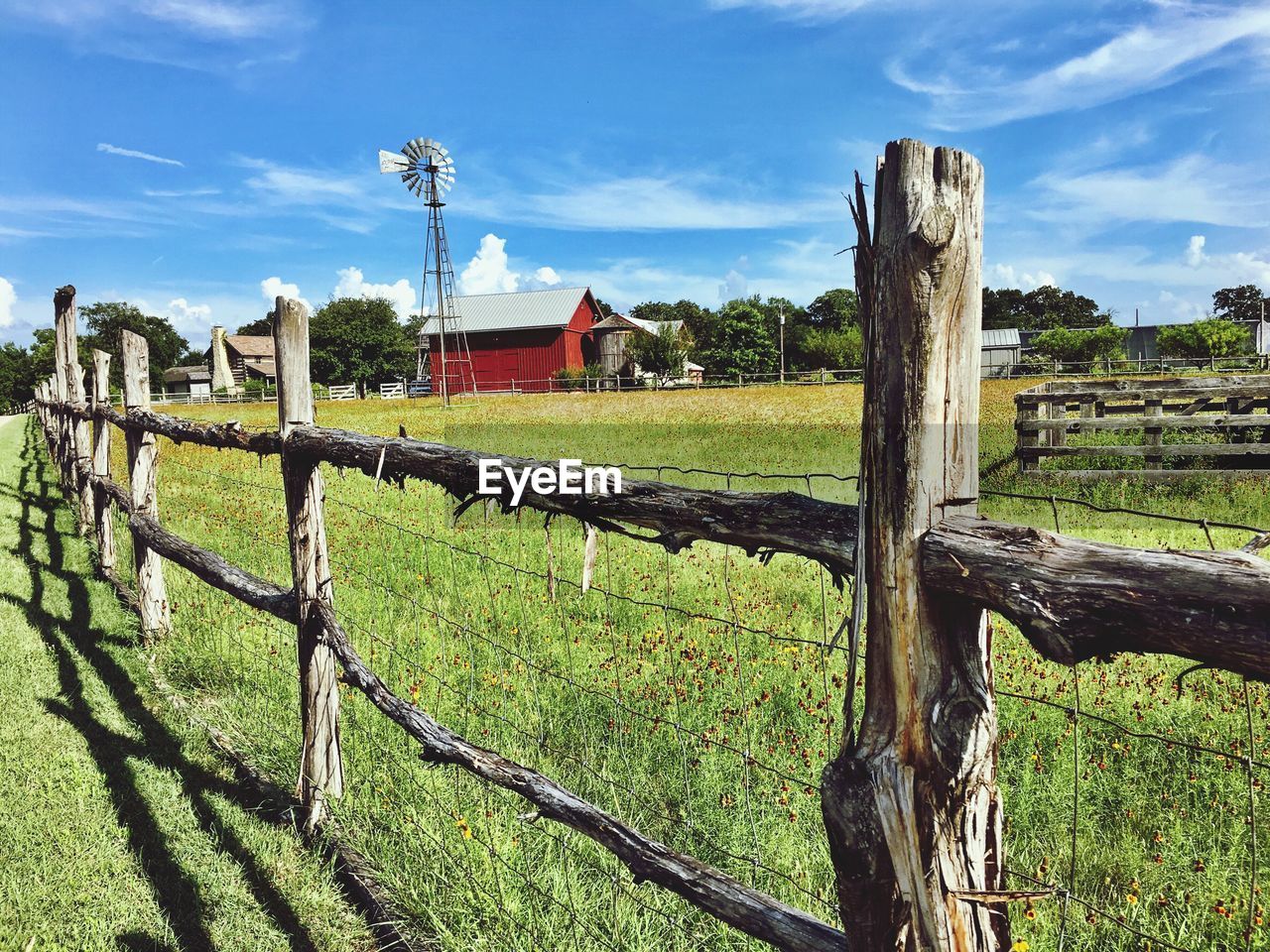 WOODEN POSTS ON FIELD