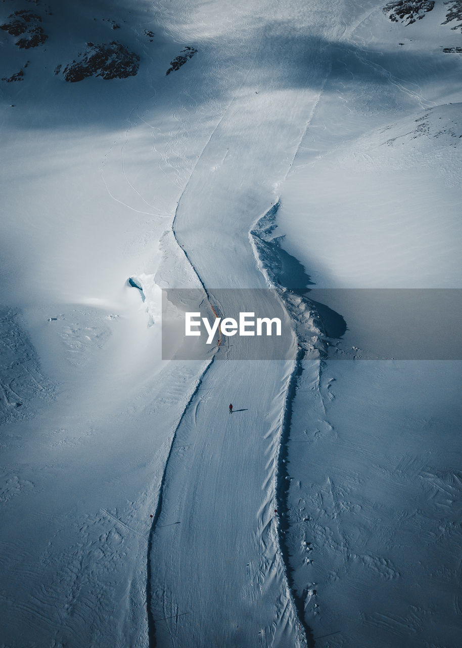 Aerial view of man standing on snow covered field