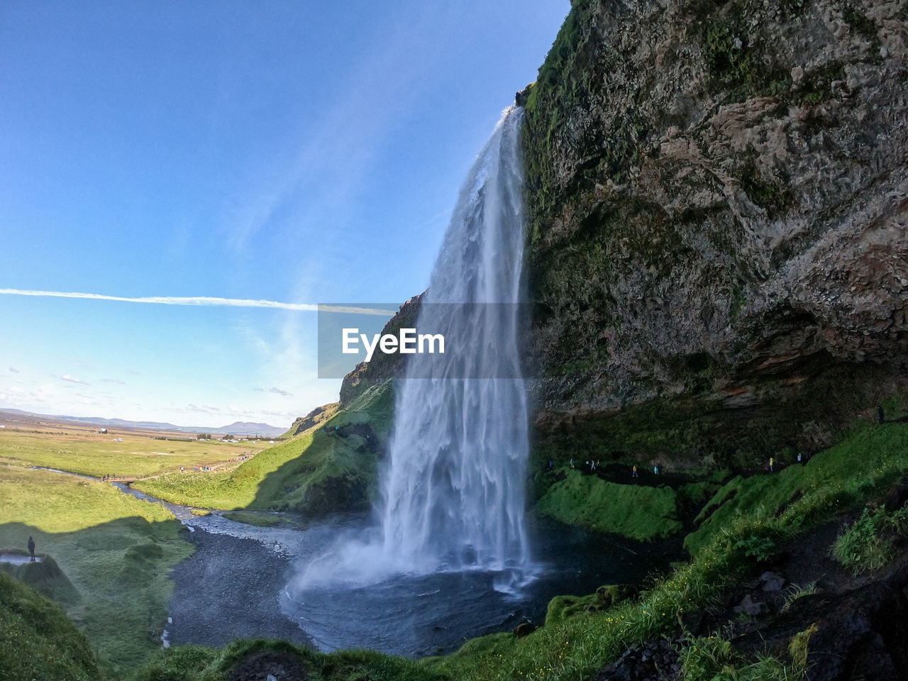 SCENIC VIEW OF WATERFALL AGAINST ROCKS