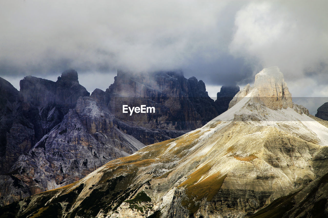 Idyllic view of dolomites against cloudy sky