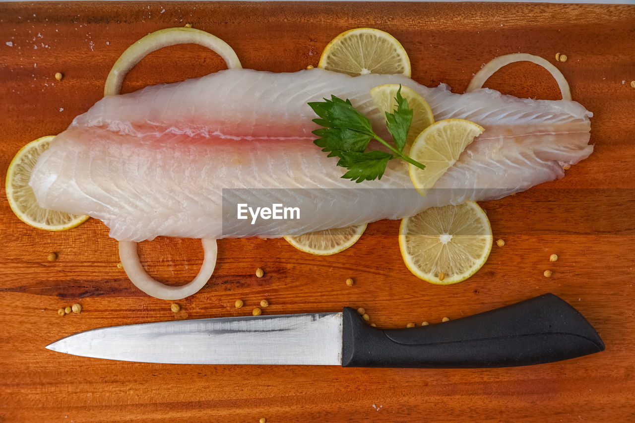 Fresh fillet dory fish on wooden tray