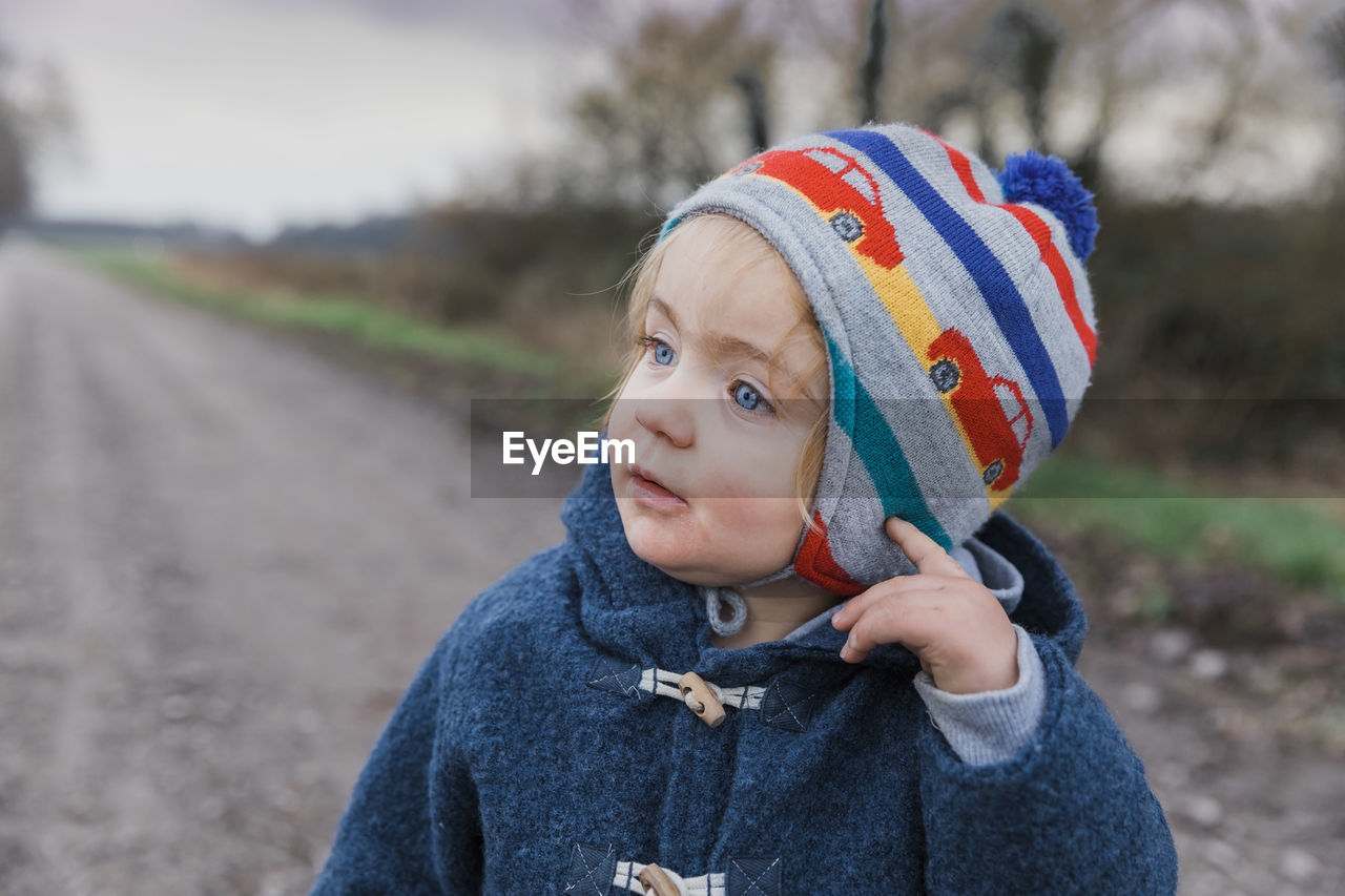 Close-up of cute girl looking away in park