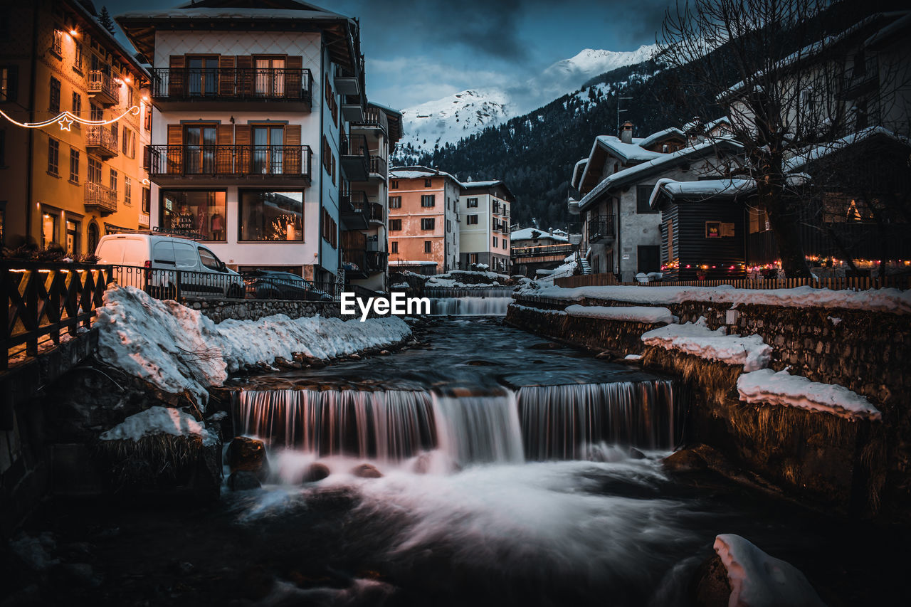 CANAL AMIDST BUILDINGS DURING WINTER