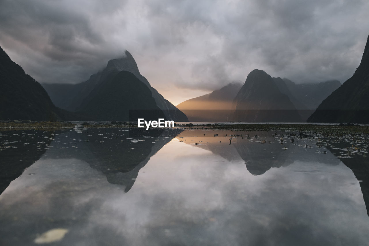 Sunset reflection with mitre peak at milford sound, new zealand