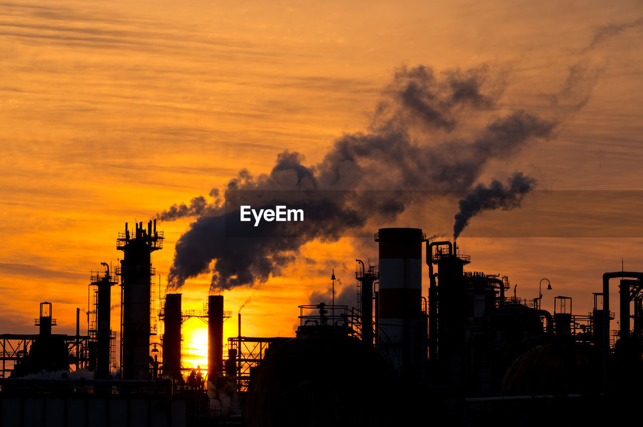 Silhouette buildings against sky during sunset