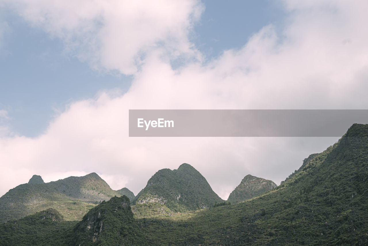 View of mountain range against cloudy sky