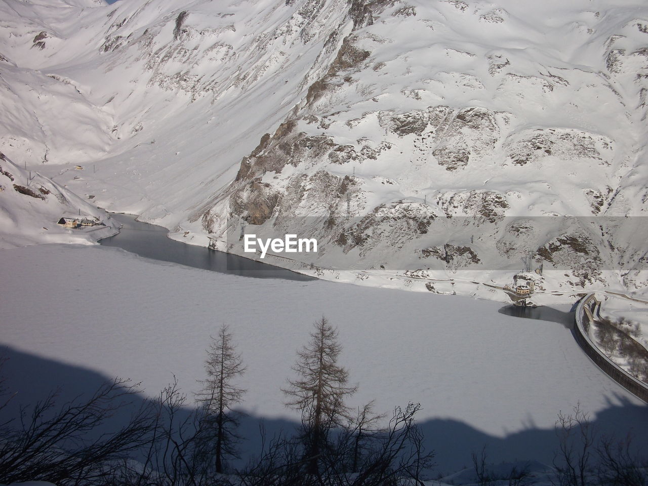 High angle view of snowcapped mountains and lake
