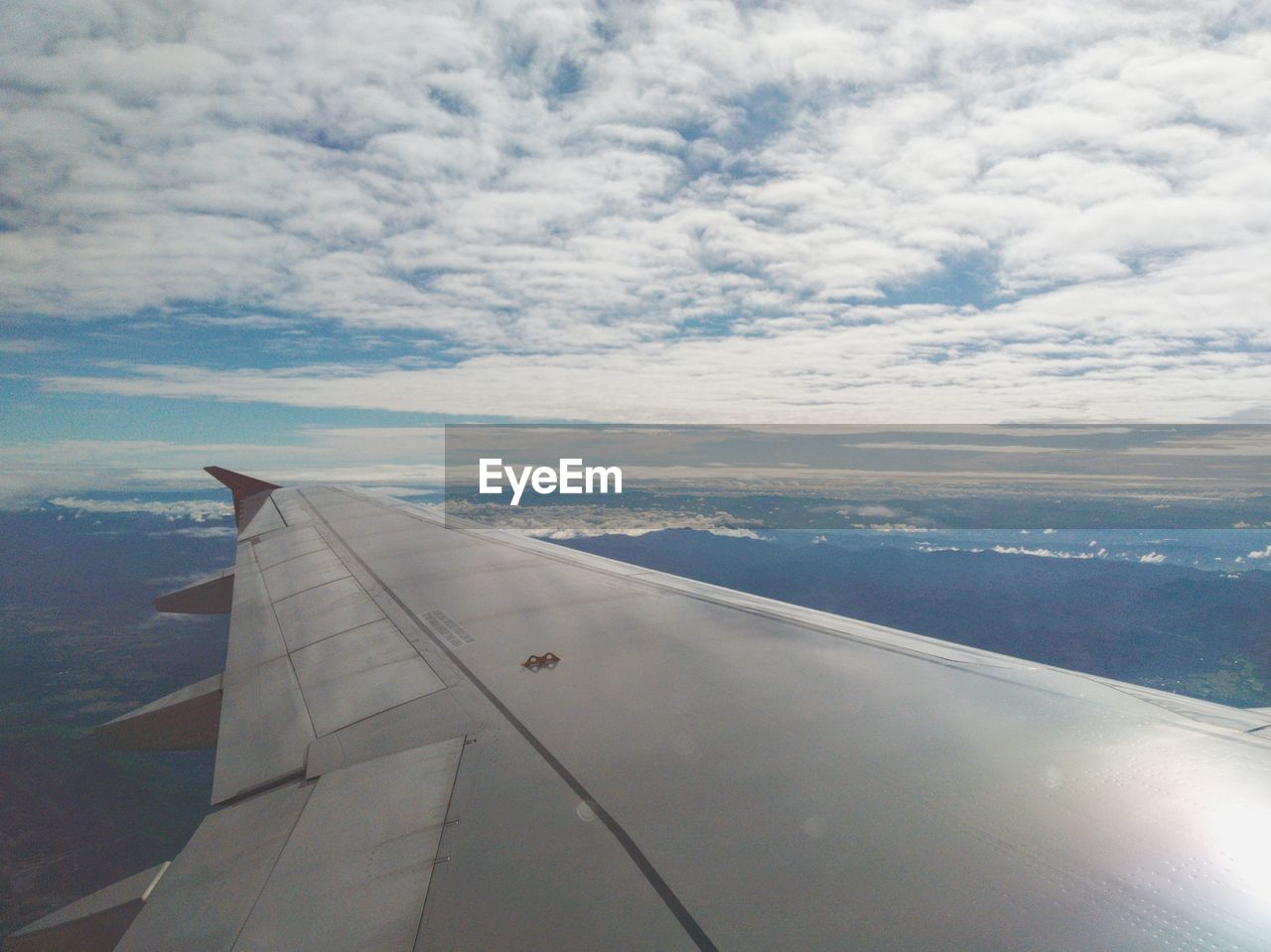 AIRPLANE FLYING OVER CLOUDS