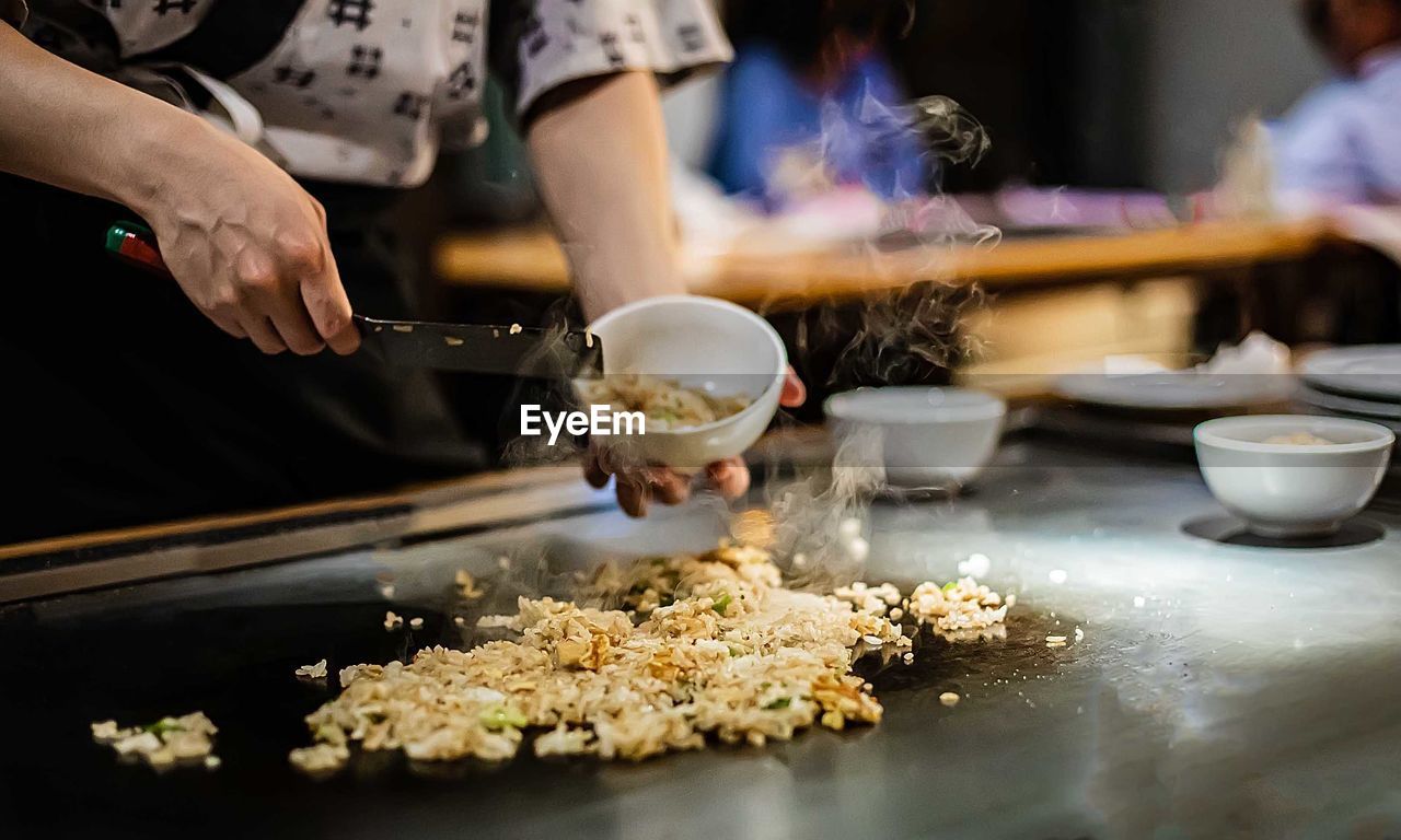 Midsection of person preparing food on table