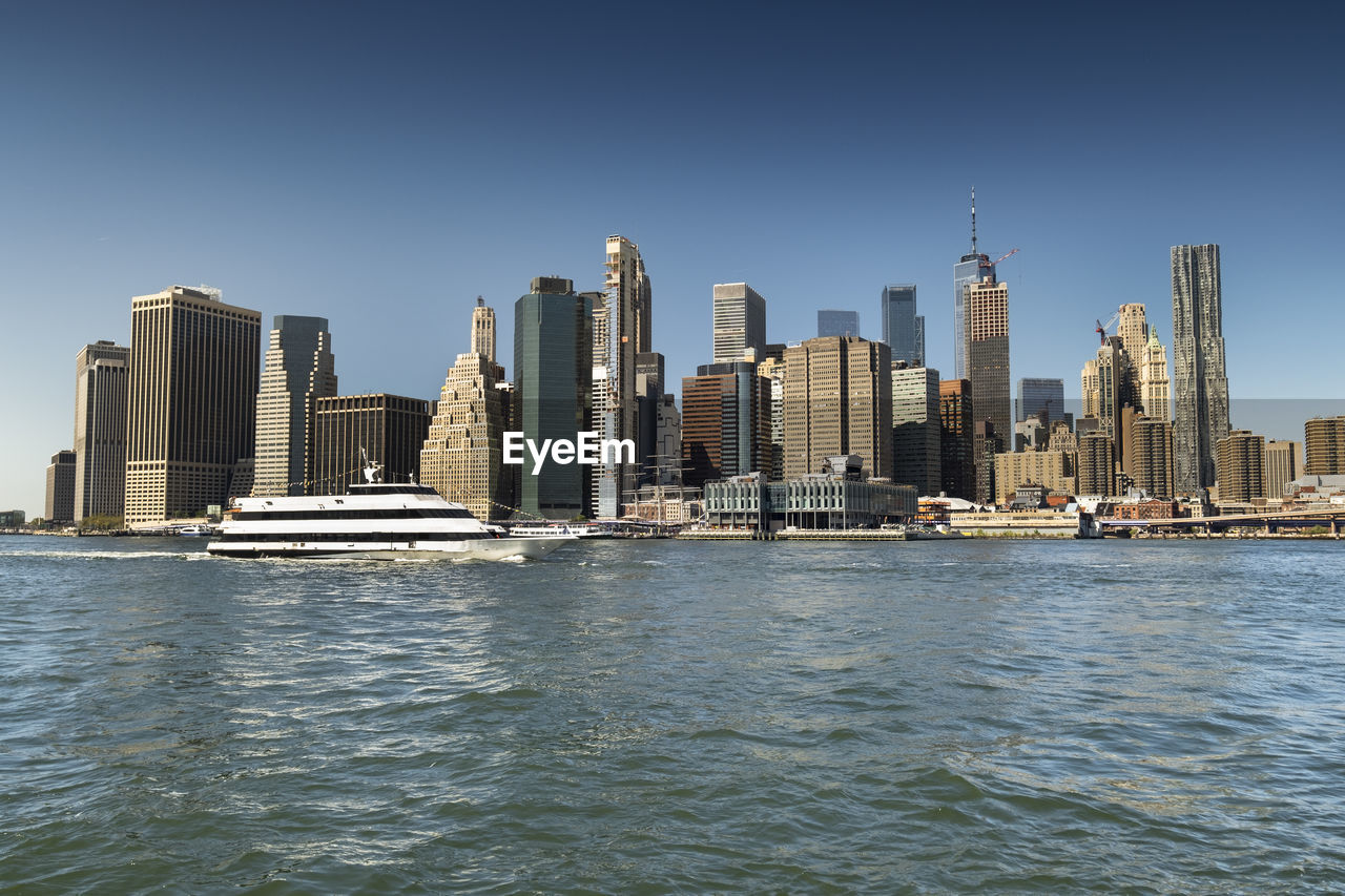 SEA AND BUILDINGS AGAINST CLEAR SKY