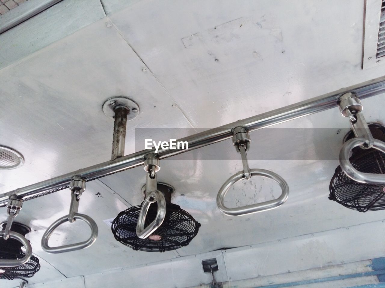 Low angle view of handles in train