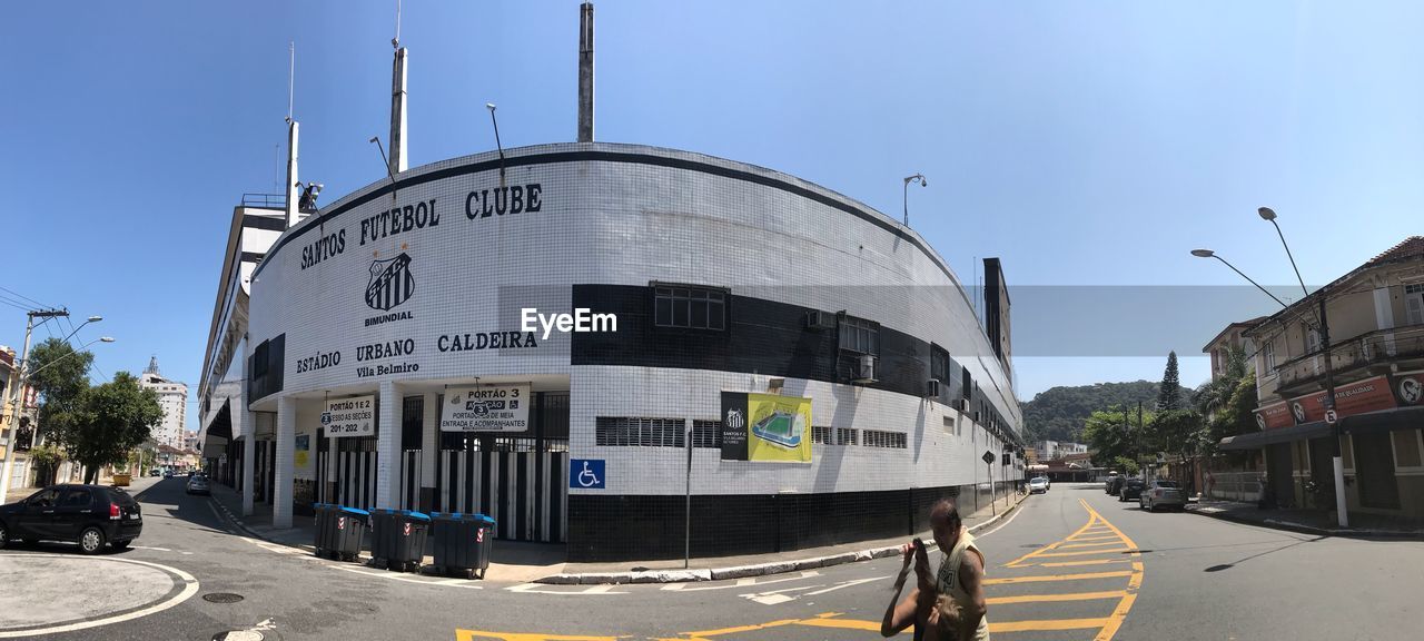 VEHICLES ON ROAD AGAINST BUILDINGS