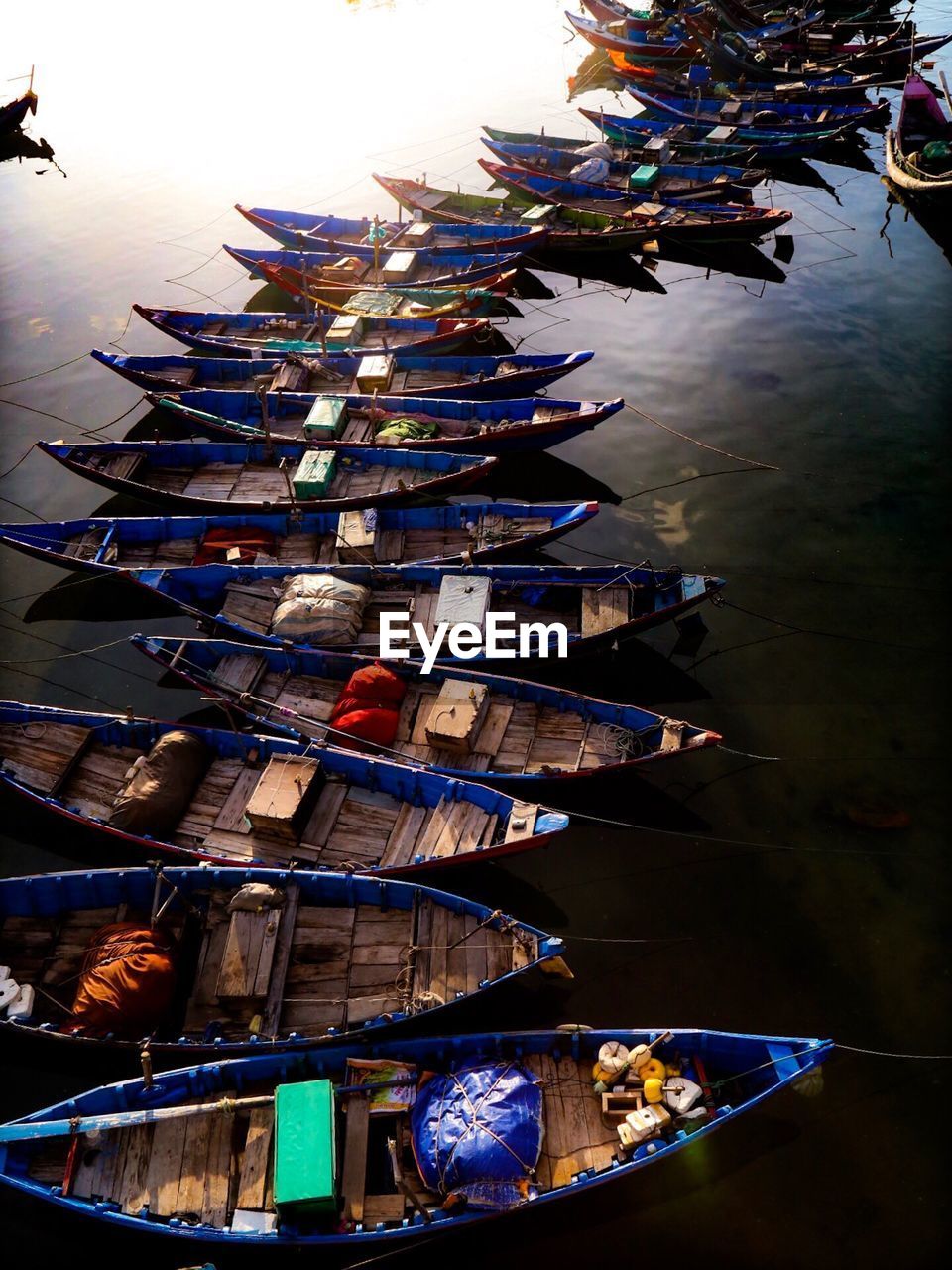 High angle view of boats moored in lake during sunset