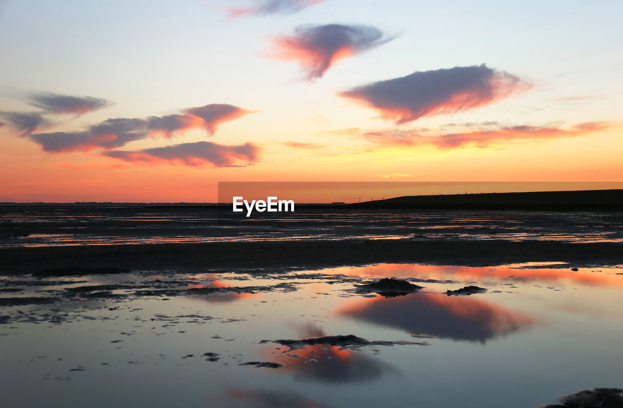 Scenic view of sea against orange sky