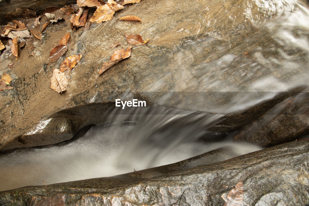 LOW ANGLE VIEW OF WATERFALL ON ROCK FORMATION