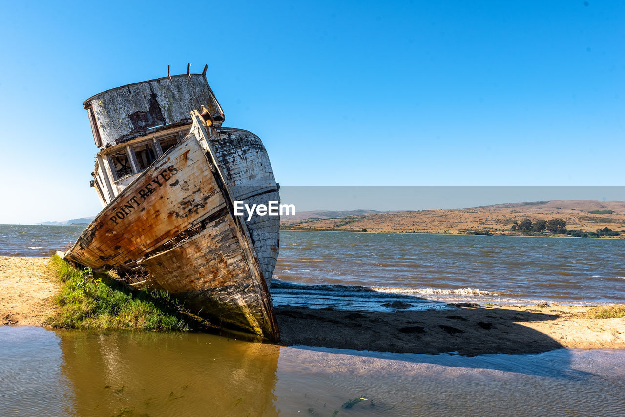 ABANDONED BOAT ON BEACH