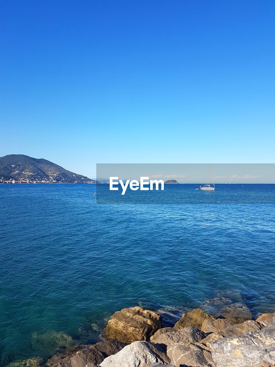 Scenic view of sea against blue sky