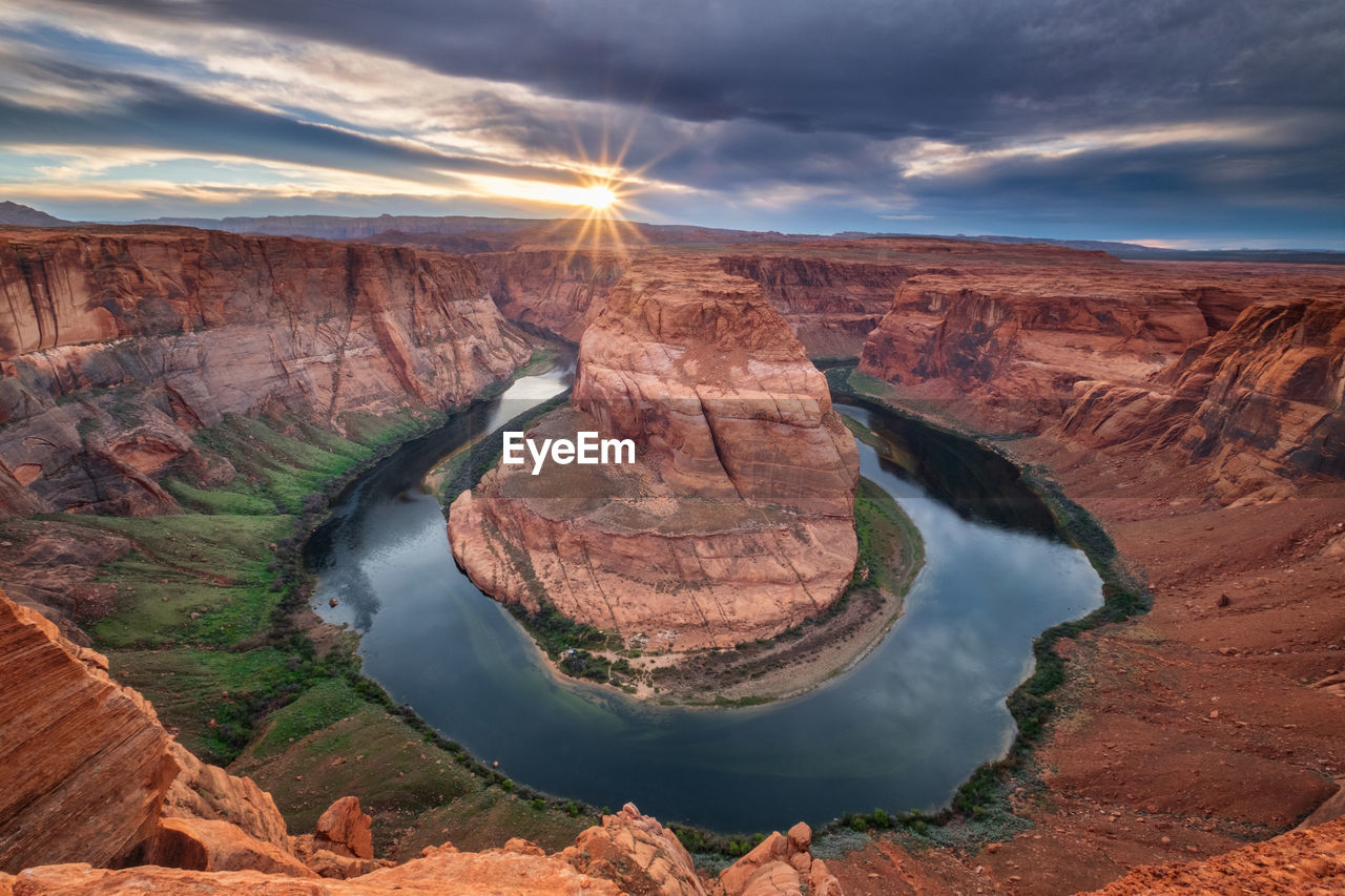 Aerial view of horseshoe bend against cloudy sky