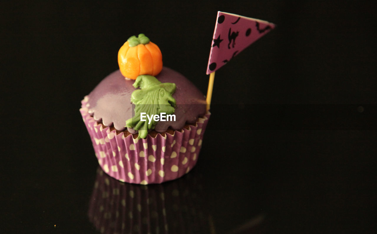 Close-up of cupcake on glass table