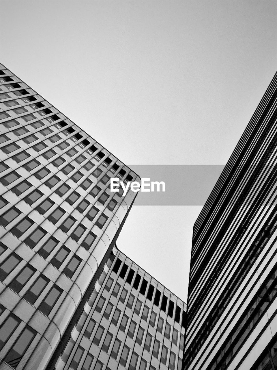 LOW ANGLE VIEW OF MODERN BUILDINGS AGAINST CLEAR SKY