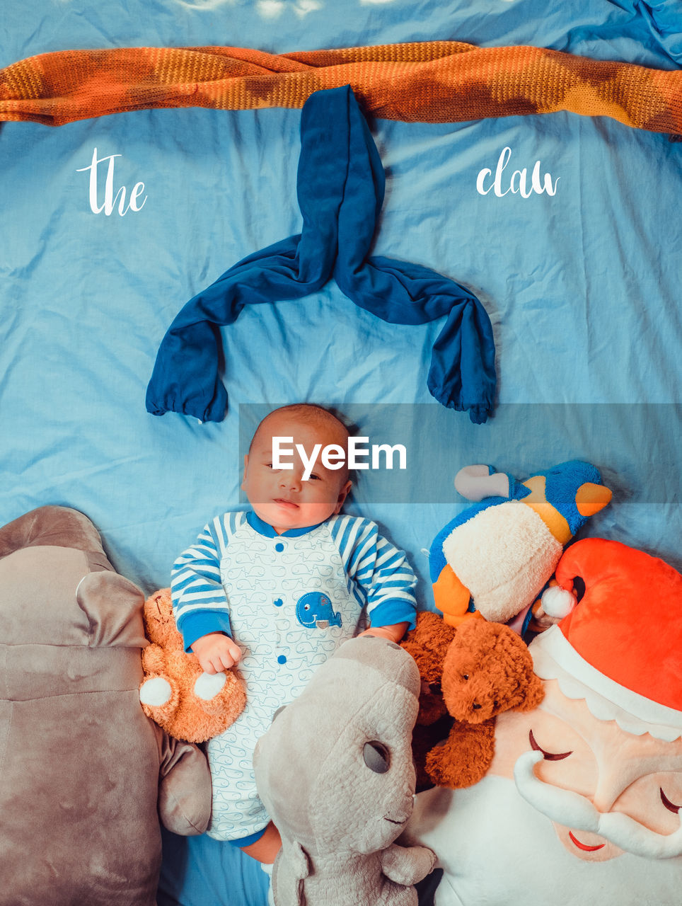 Portrait of cute baby boy lying down on bed