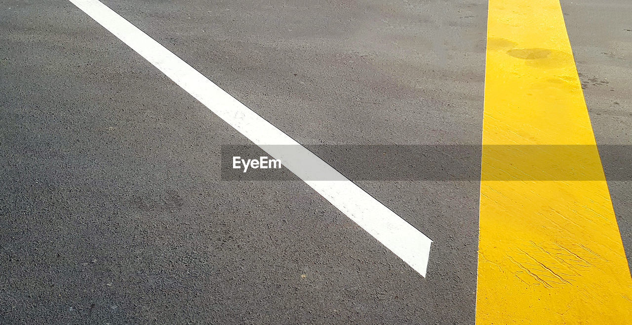 High angle view of arrow sign on road