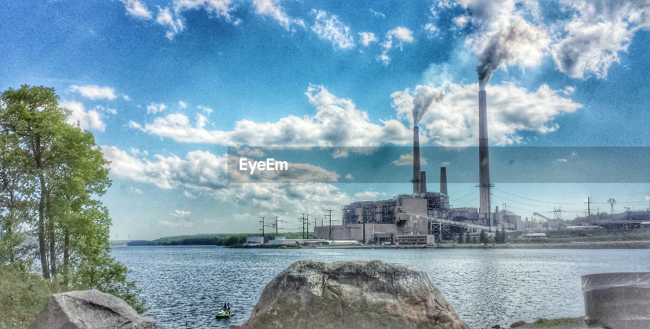 VIEW OF BUILT STRUCTURES AGAINST CLOUDY SKY