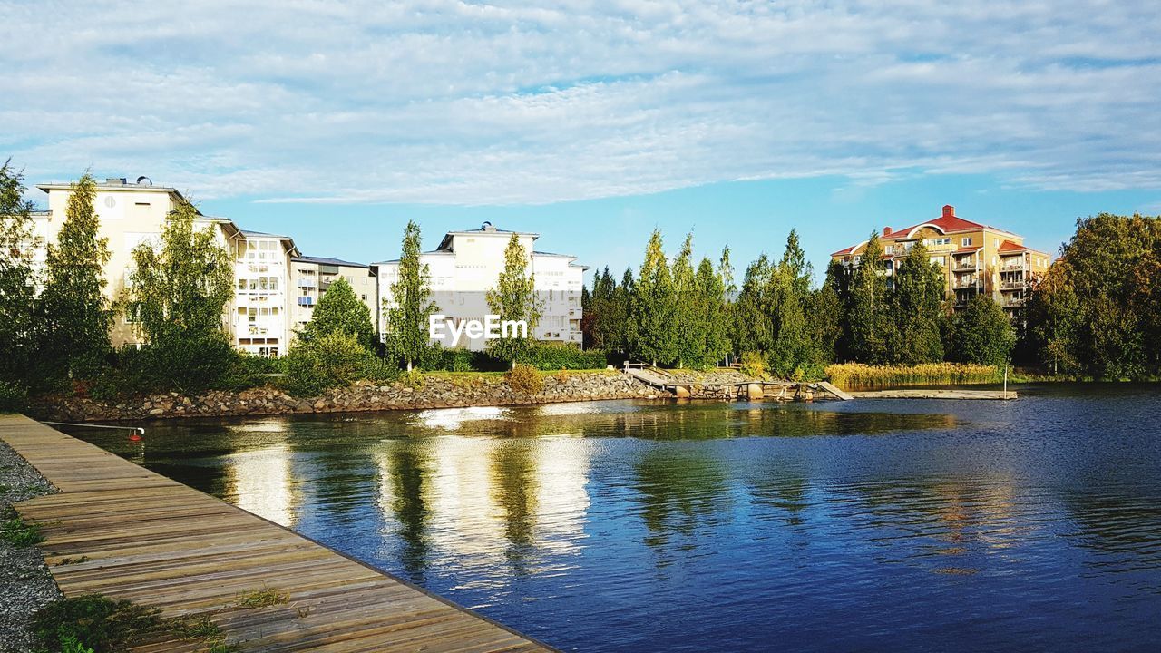 RIVER AND BUILDINGS AGAINST SKY