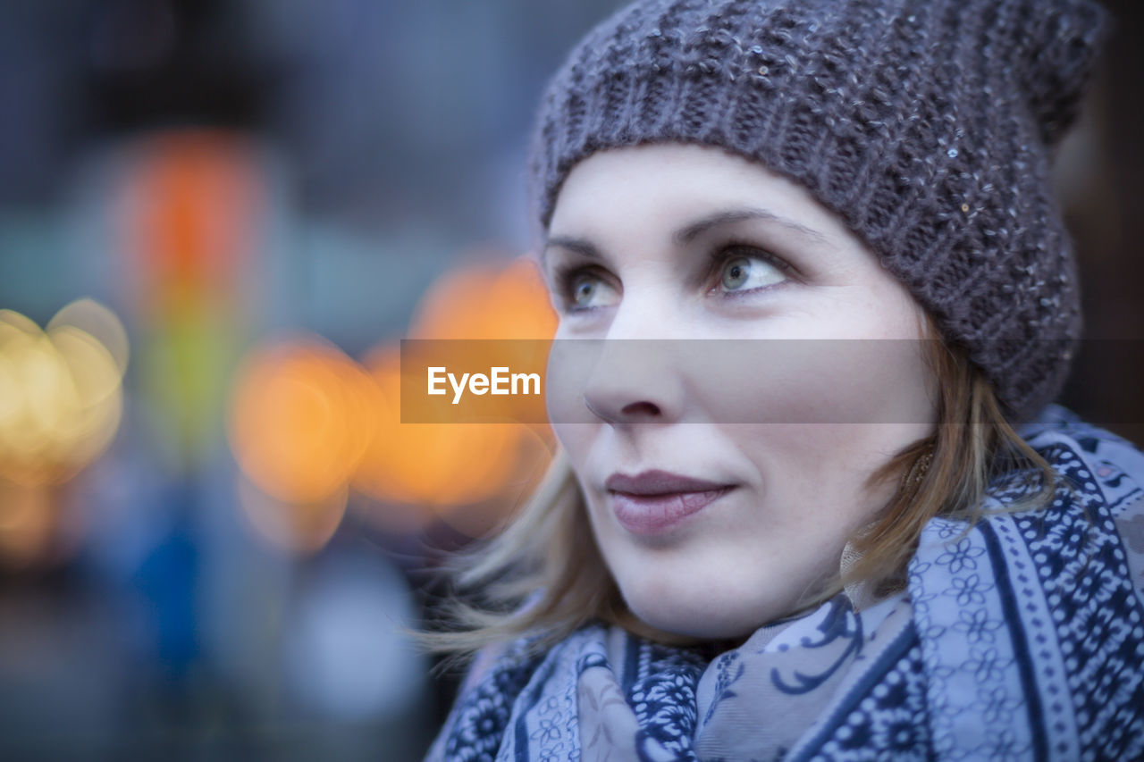 Close-up of woman wearing knit hat standing outdoors during winter