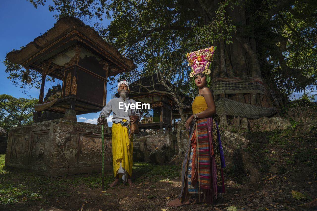 Balineese holyman and rejang dancer with ancient view