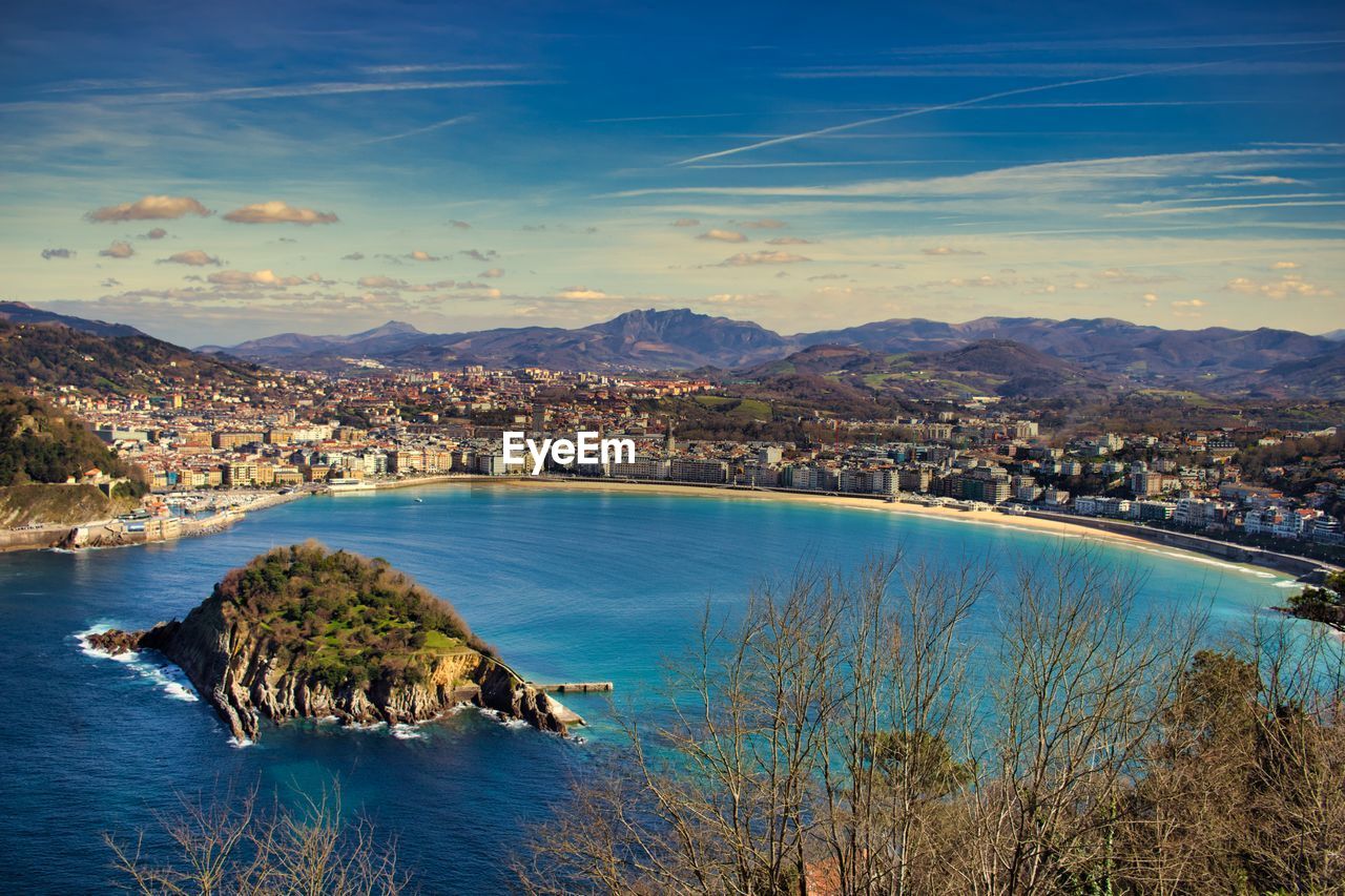 High angle view of sea and cityscape against sky