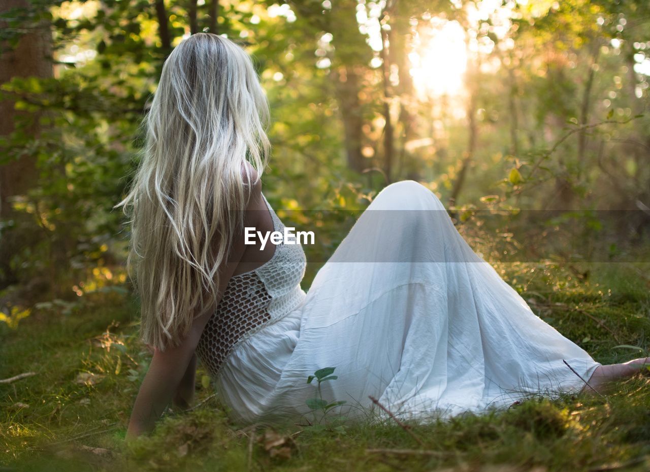 Woman sitting on grassy field