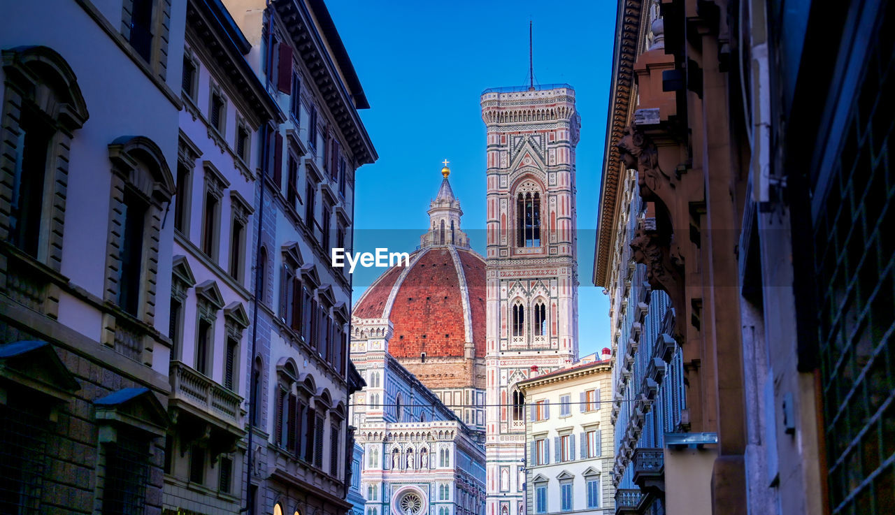 Low angle view of cathedral by buildings in city