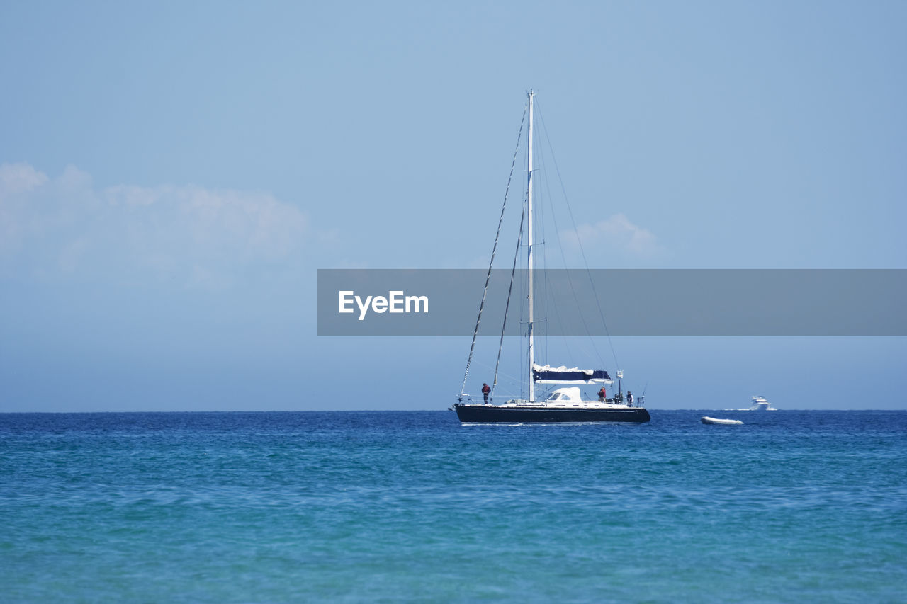 Ship sailing on sea against clear sky