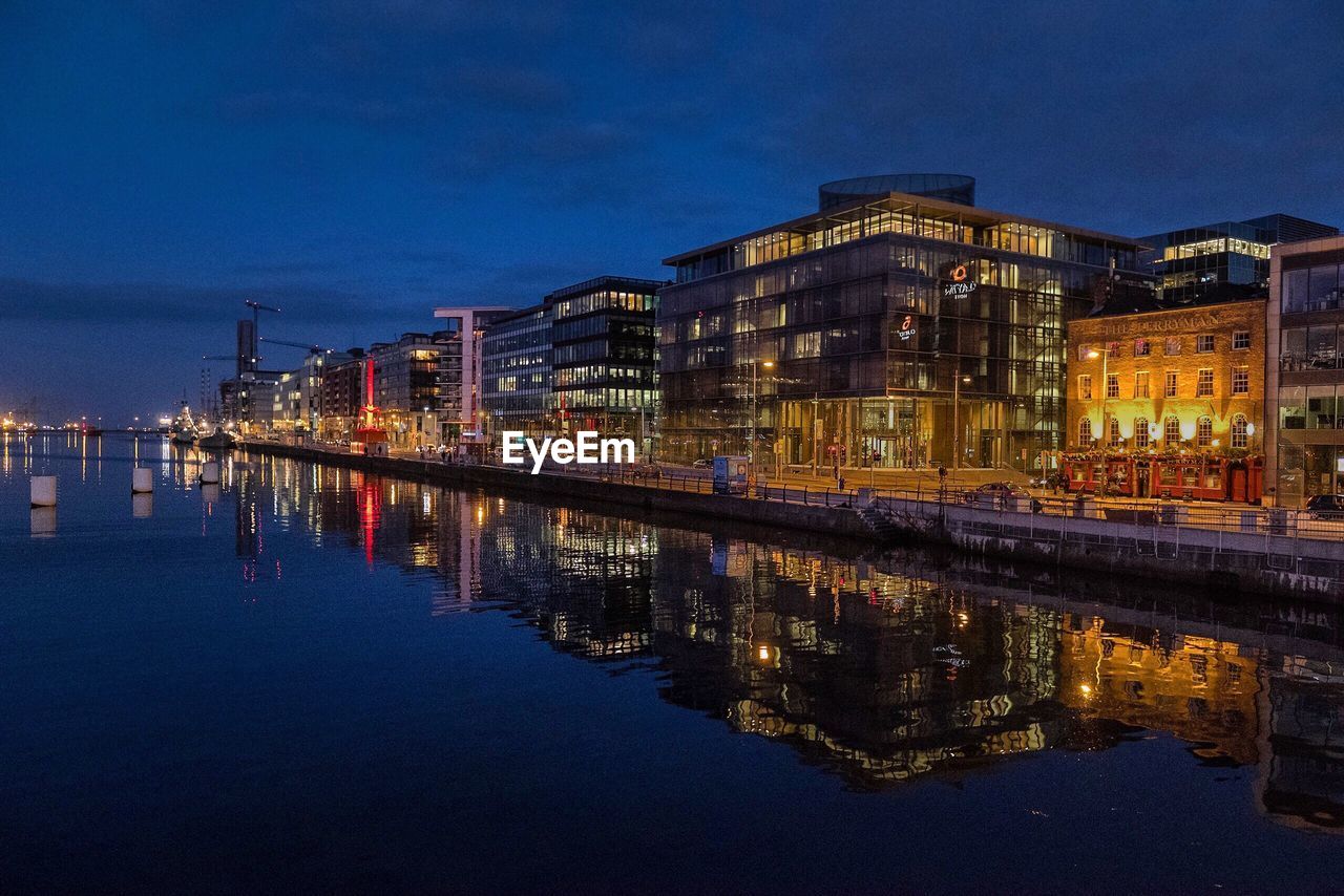 Reflection of illuminated buildings in water at night