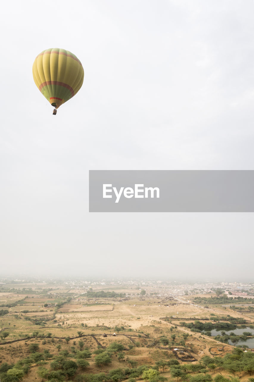 High flying balloon over rural area in pushkar,rajasthan, india