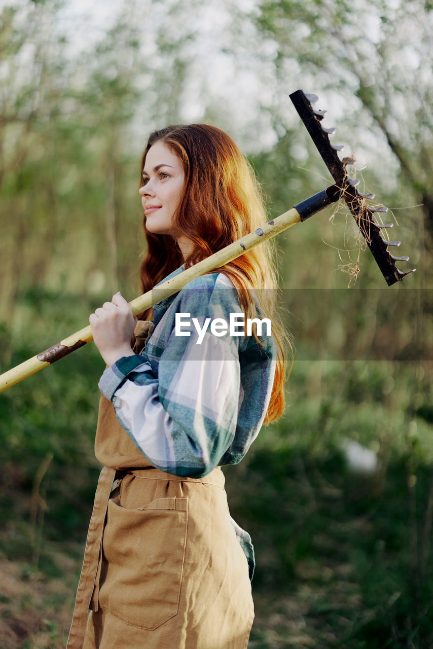 Smiling woman holding farmer rack