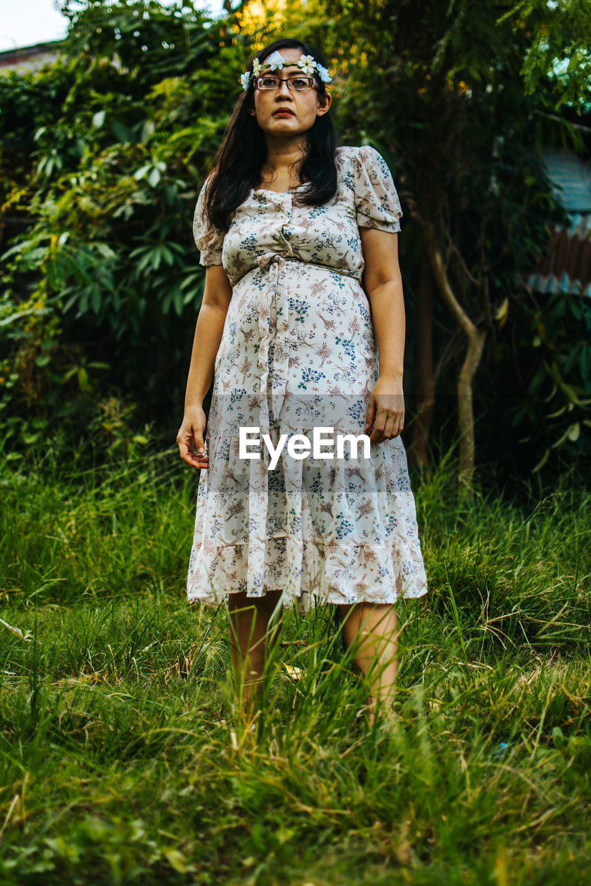 Portrait of woman standing on field