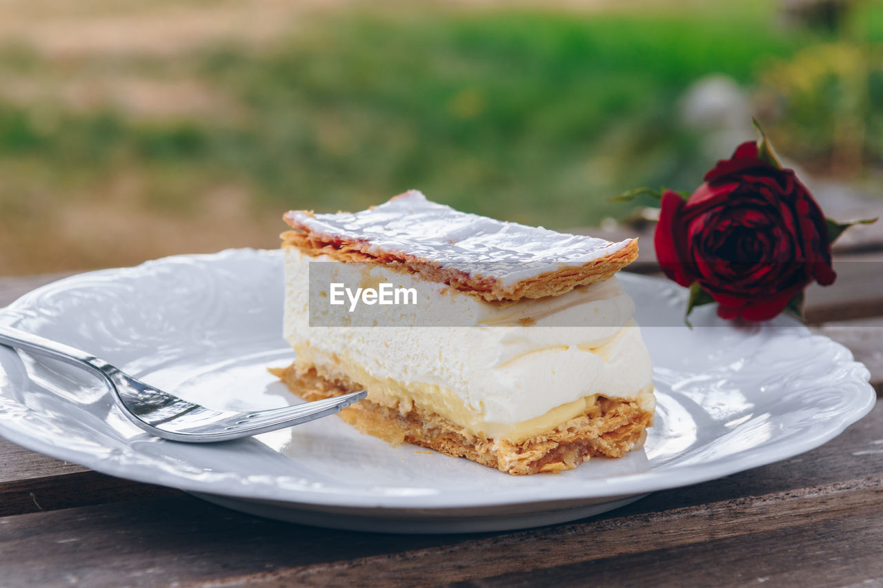 Close-up of mille-feuille in plate on table outdoors