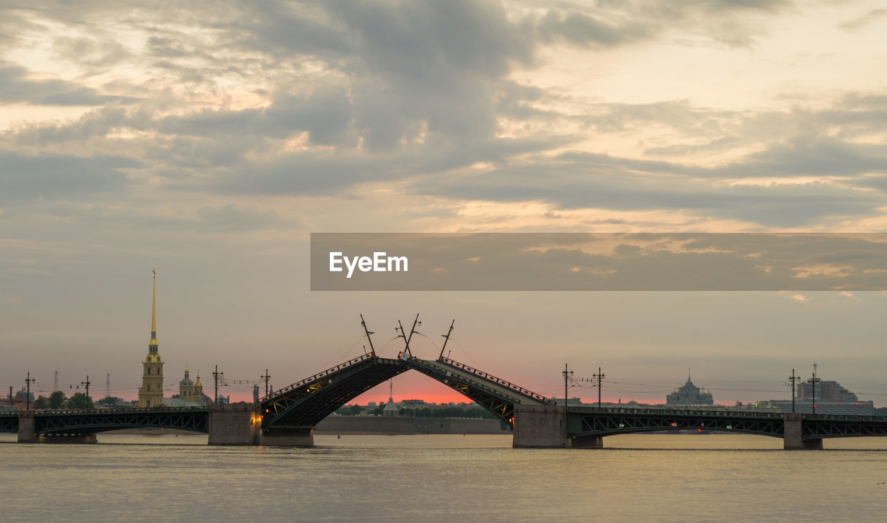 View of bridge over river against cloudy sky