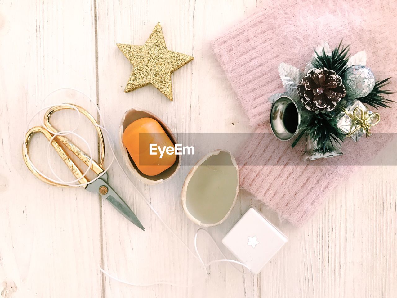 Directly above shot of christmas decorations and scissors on table