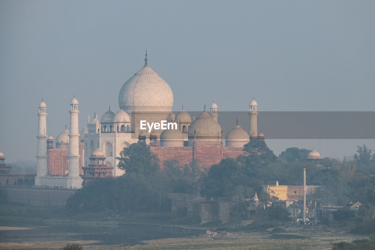 Taj mahal seen in the distance from agra fort at sunset, agra.