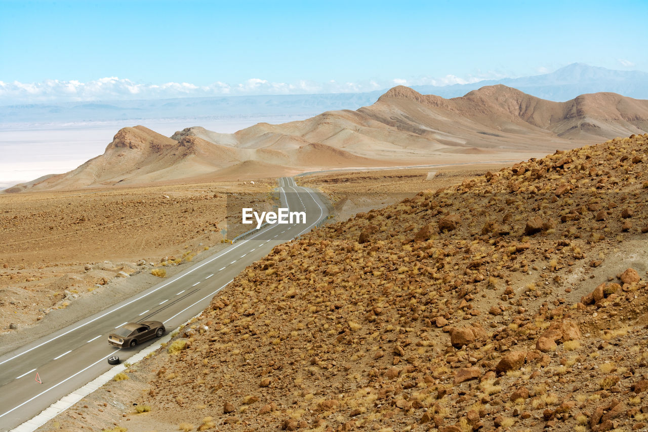 Scenic view of desert road against sky