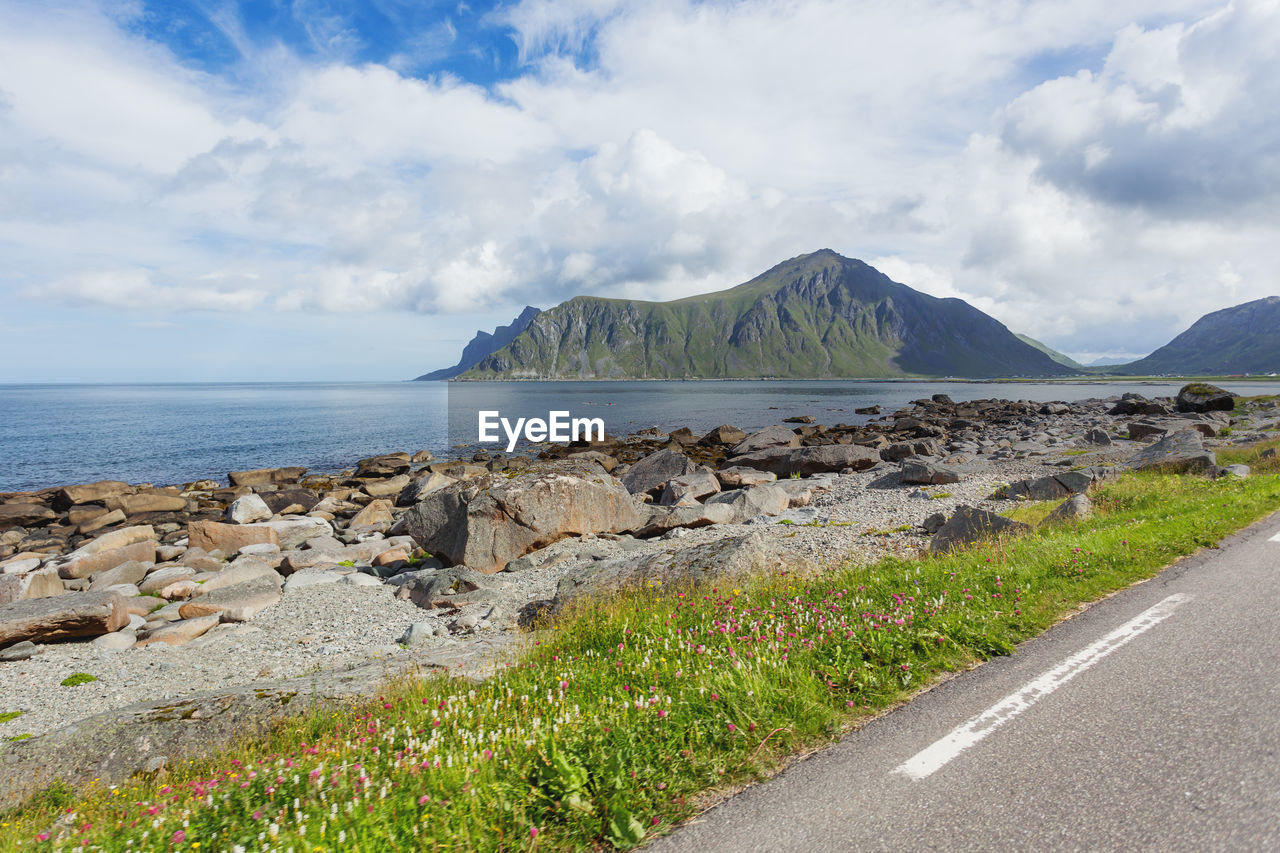 sky, water, coast, cloud, sea, scenics - nature, land, shore, beauty in nature, nature, mountain, horizon, landscape, environment, road, transportation, travel destinations, travel, beach, rock, tranquil scene, no people, tranquility, day, body of water, ocean, non-urban scene, vacation, outdoors, terrain, tourism, cliff, coastline, bay, plant, grass, idyllic